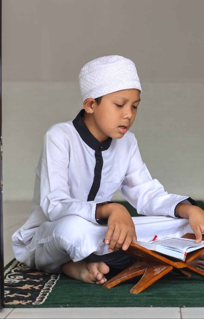 muslim-kid-boy-reciting-koran-or-qur-an-2022-12-15-01-28-15-utc (1)